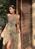 woman wearing floral Garden on Eden Dress standing by wooden shutters in sunlight